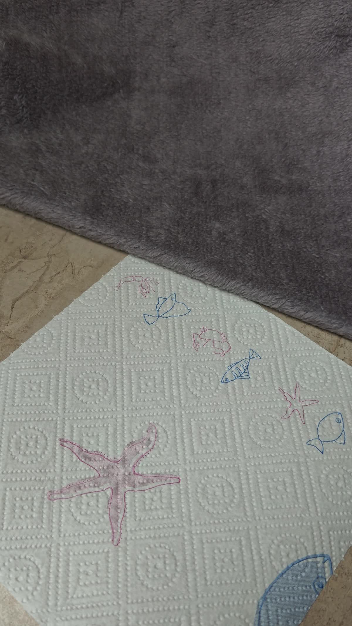 Actual product footage showing the plain grey plush backing