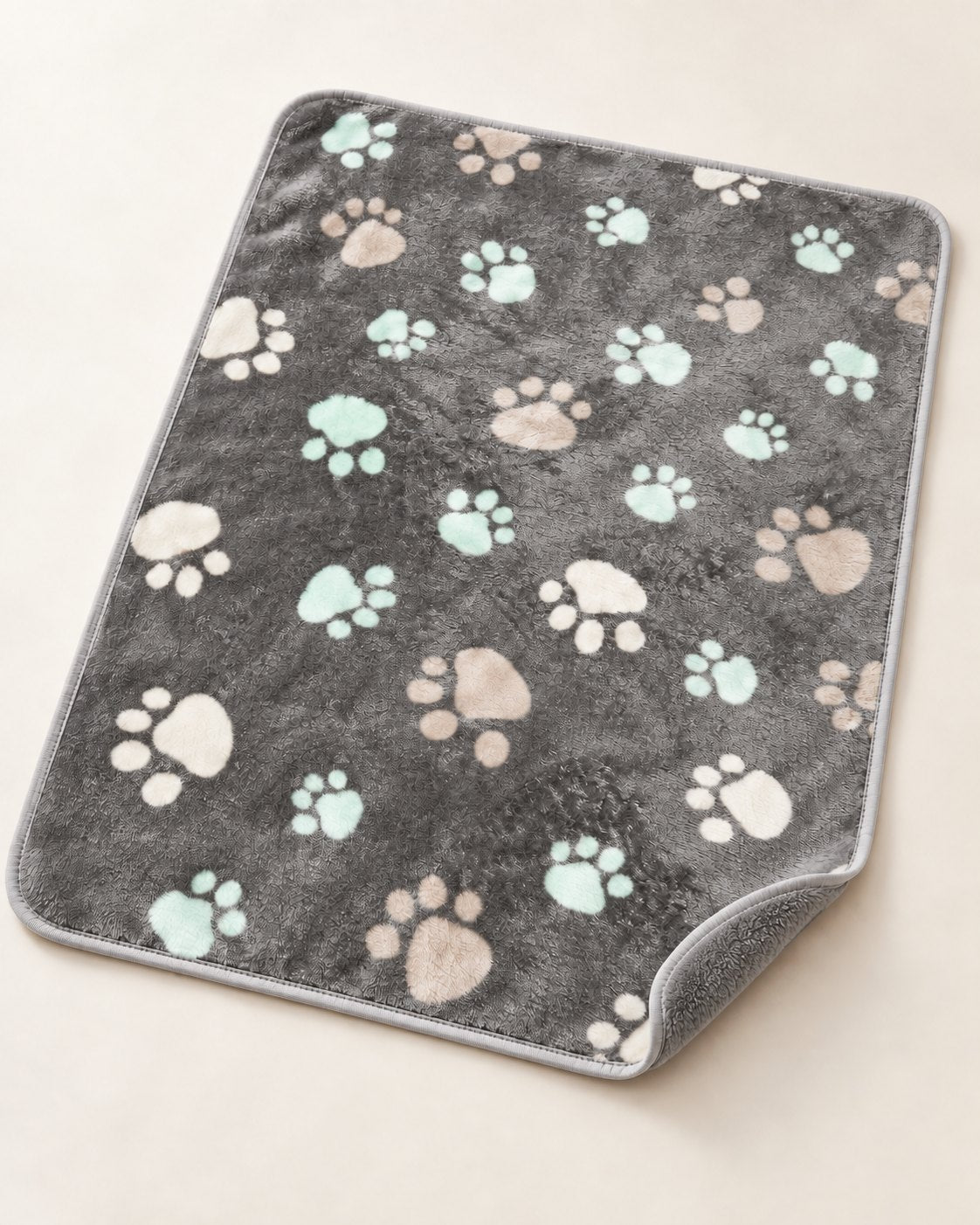 Grey paw-print mat with a plain grey reverse at the folded corner